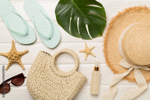 Beach accessories on wooden background, flat lay