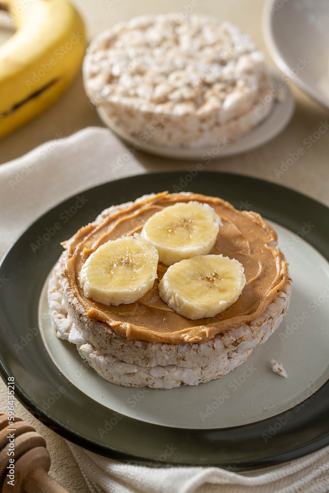 Puffed rice cake with banana and peanut butter, healthy protein snack. Puffed rice cake with banana and peanut butter, healthy protein snack.