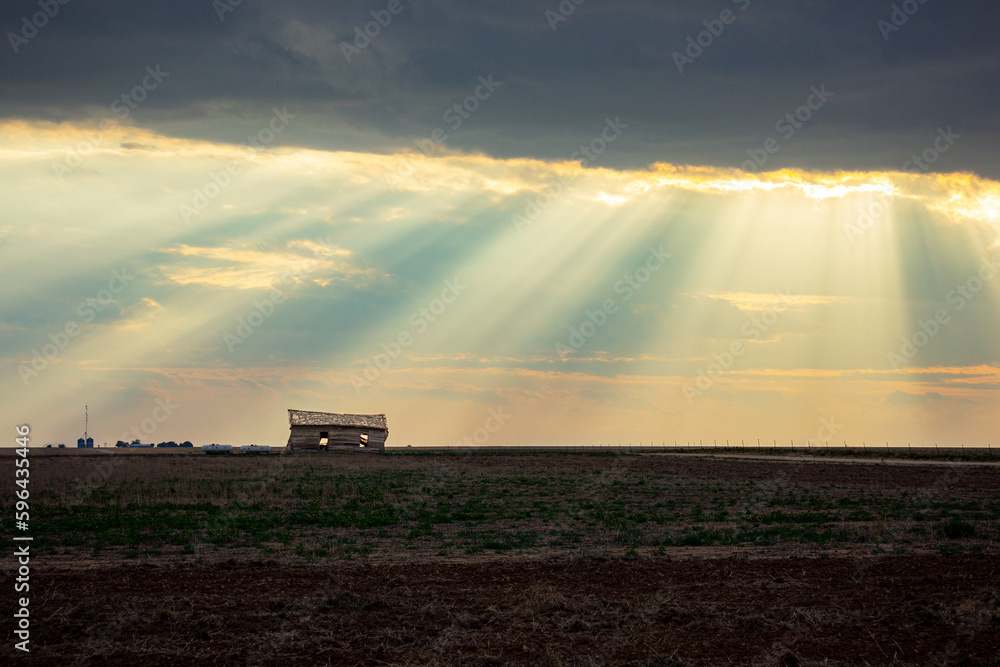 Fototapeta premium Sunbeams Shine on Abandoned Building in Rural Farmland