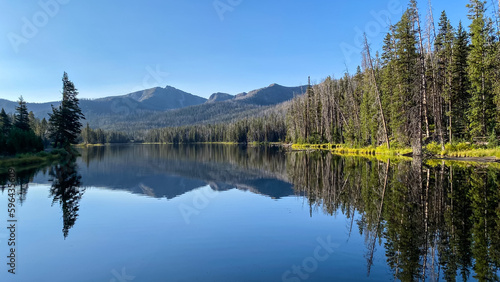 Sylvan Lake morning reflections of the trees and mountains in Yellowstone National Park © Kurt