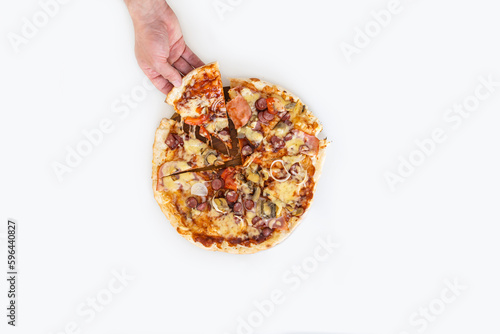 Hand taking a slice of pizza. Big barbecue pizza. Top view on paperoni pizza. Concept for italian food, street food, fast food, quick bite. photo