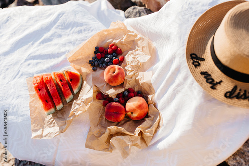 beautiful picnic with fruits on a stone by the sea