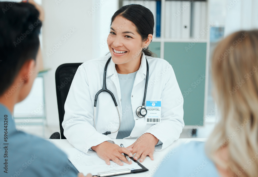 Happiness is the highest form of health. Shot of a couple consulting with a doctor at a clinic. Happiness is the highest form of health. Shot of a couple consulting with a doctor at a clinic.