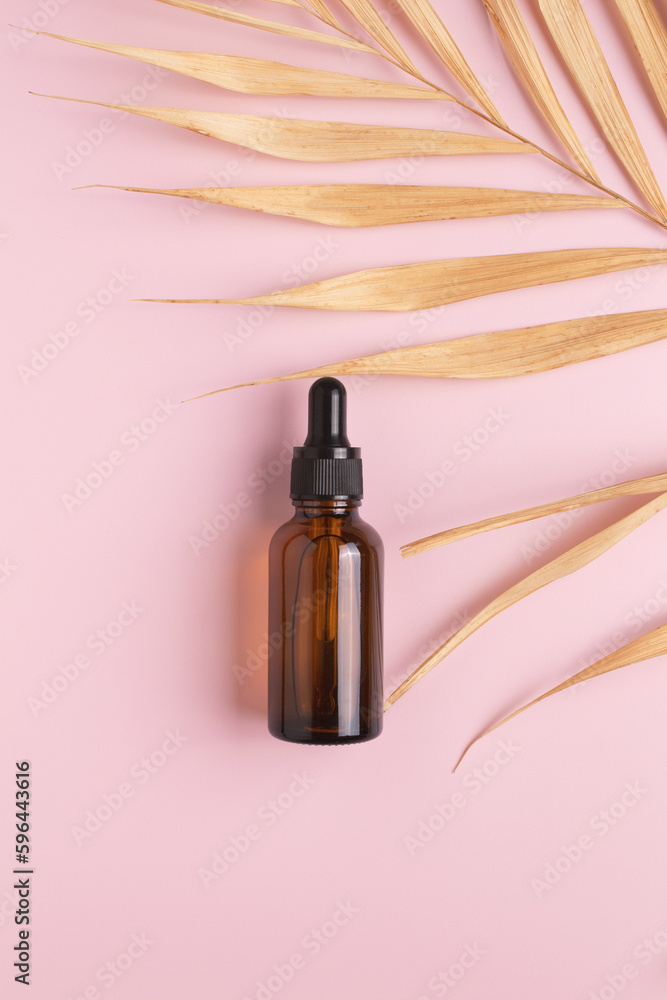 Cosmetic bottle with body and face oil and palm leaf, summer natural cosmetics, serum, facial oil, tropical concept. Cosmetic bottle with body and face oil and palm leaf, summer natural cosmetics, serum, facial oil, tropical concept.