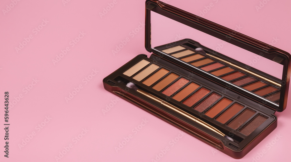 Set of nude brown eyeshadow in a palette on pink background Set of nude brown eyeshadow in a palette on pink background