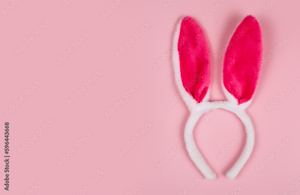 greeting card with bunny ears on pink background. happy easter. Copy space