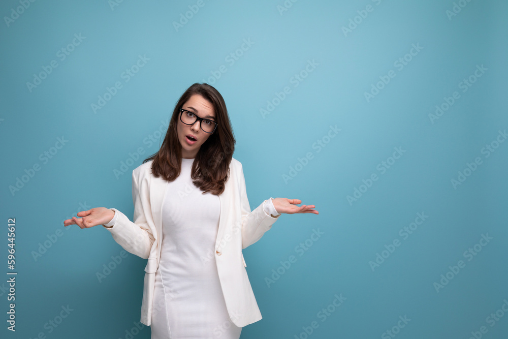 suspicious young woman in business attire looks at camera in studio suspicious young woman in business attire looks at camera in studio