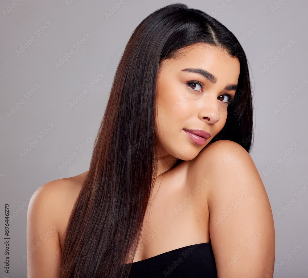 Feeling extra confident today. Studio portrait of an attractive young woman posing against a grey background. Feeling extra confident today. Studio portrait of an attractive young woman posing against a grey background.