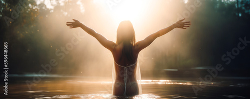 A woman wears a transparent veil in a lake, spreading her arms towards a divine light that appears in the sky. Describing a moment of good news. Generative AI photo