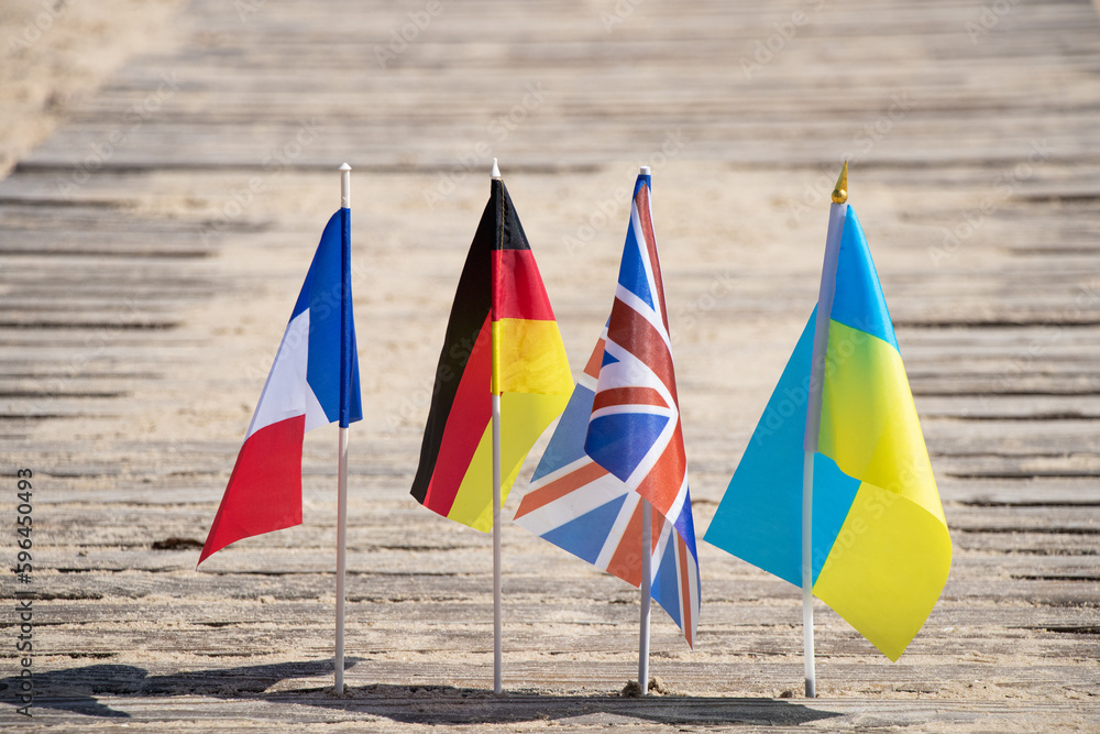 Flags of Germany and France and Great Britain and Ukraine on the sand in Ukraine on the shore, flags of countries and friendship