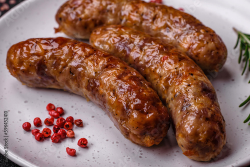 Delicious fried grilled sausages with salt, spices and herbs