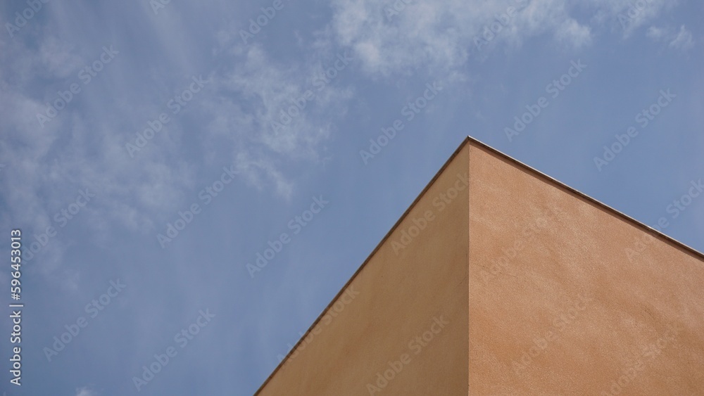 cornice corner of building against cloudy sky cornice corner of building against cloudy sky