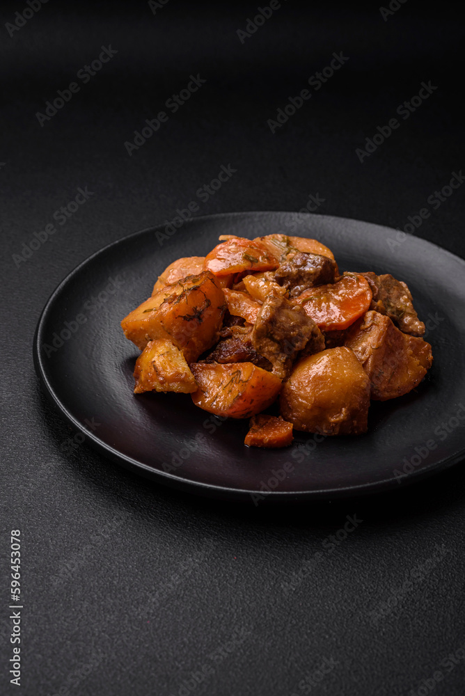 Delicious fresh cooked stew with pork meat or beef with potatoes, carrots, spices and herbs Delicious fresh cooked stew with pork meat or beef with potatoes, carrots, spices and herbs