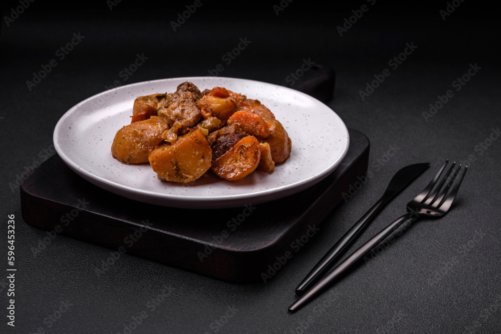 Delicious fresh cooked stew with pork meat or beef with potatoes, carrots, spices and herbs Delicious fresh cooked stew with pork meat or beef with potatoes, carrots, spices and herbs