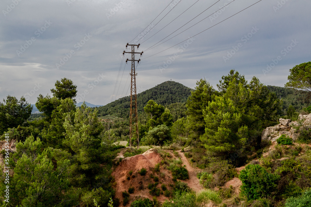 High voltage electric line through hills.