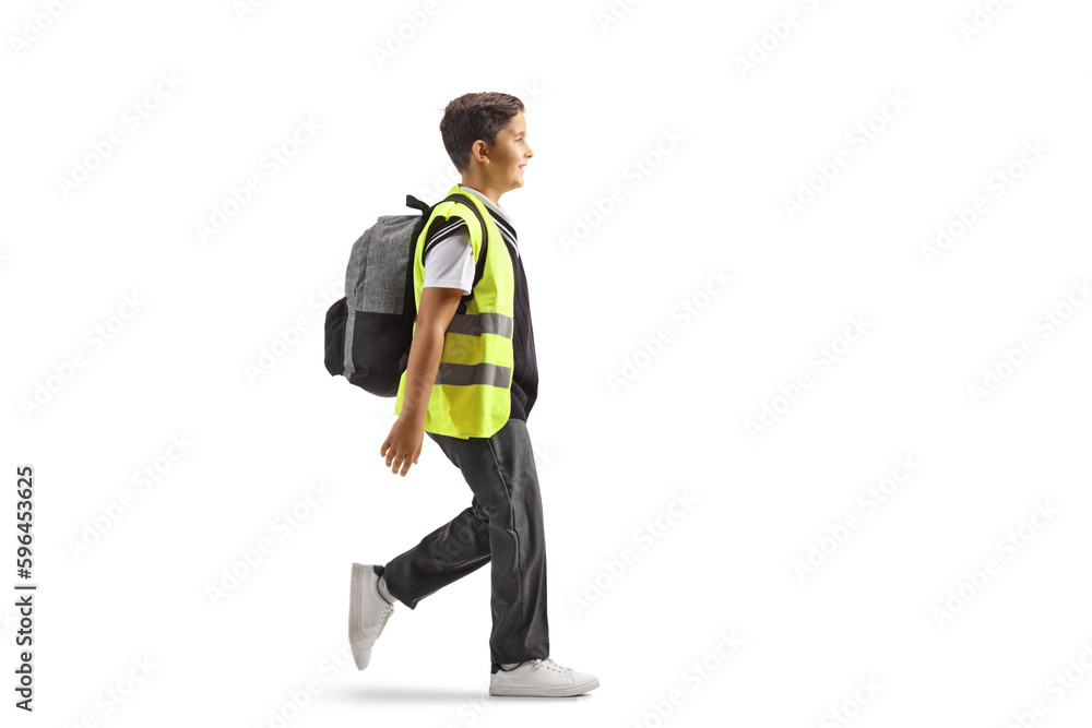 Full length profile shot of a schoolboy wearing a safety vest and walking Full length profile shot of a schoolboy wearing a safety vest and walking