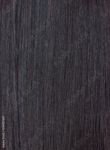 Close up of a section of glossy straight brown hair. Showing hair treatment results after keratin straightening