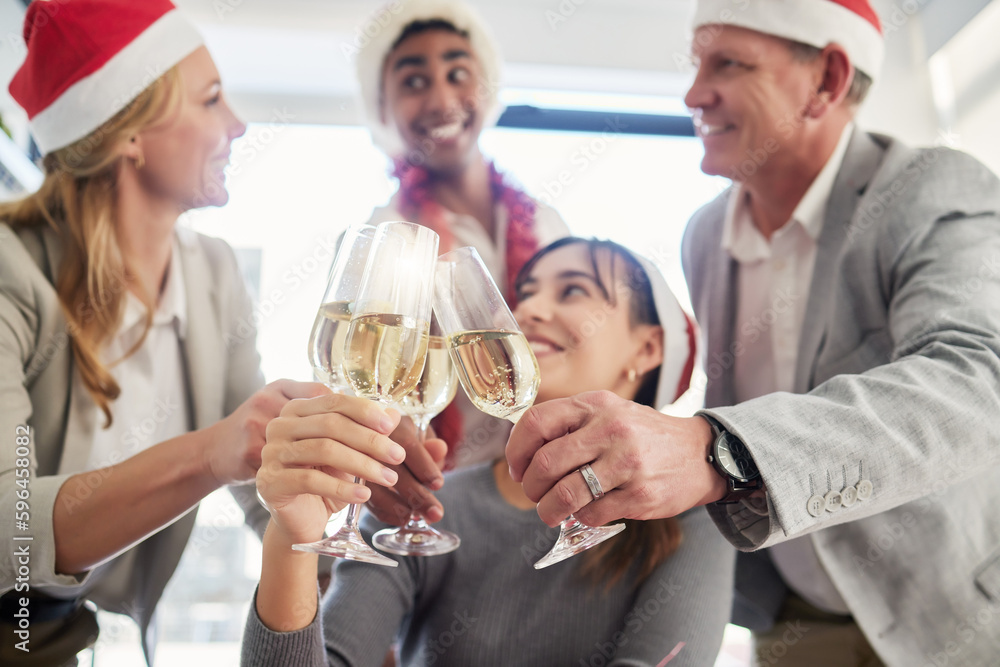 The end of the year is here. Shot of a group of business colleagues having a celebratory drink in an office.