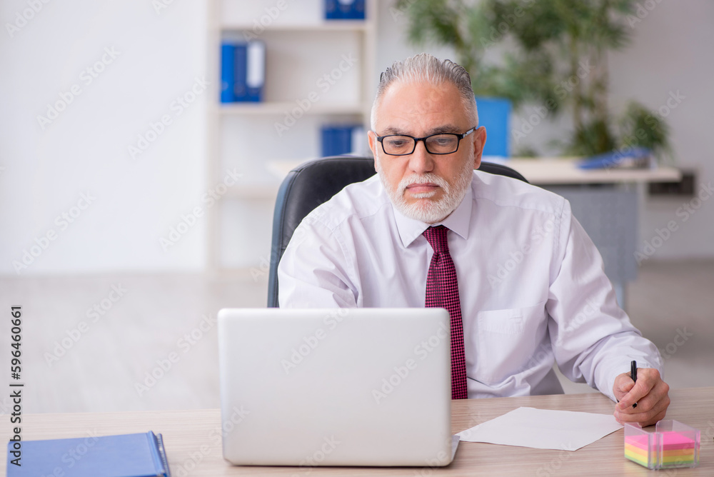 Old male employee and too much work in the office Old male employee and too much work in the office
