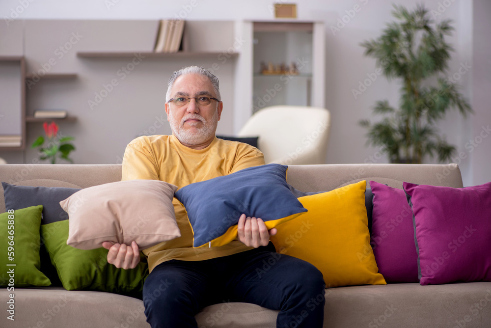 Old man with many pillows at home Old man with many pillows at home