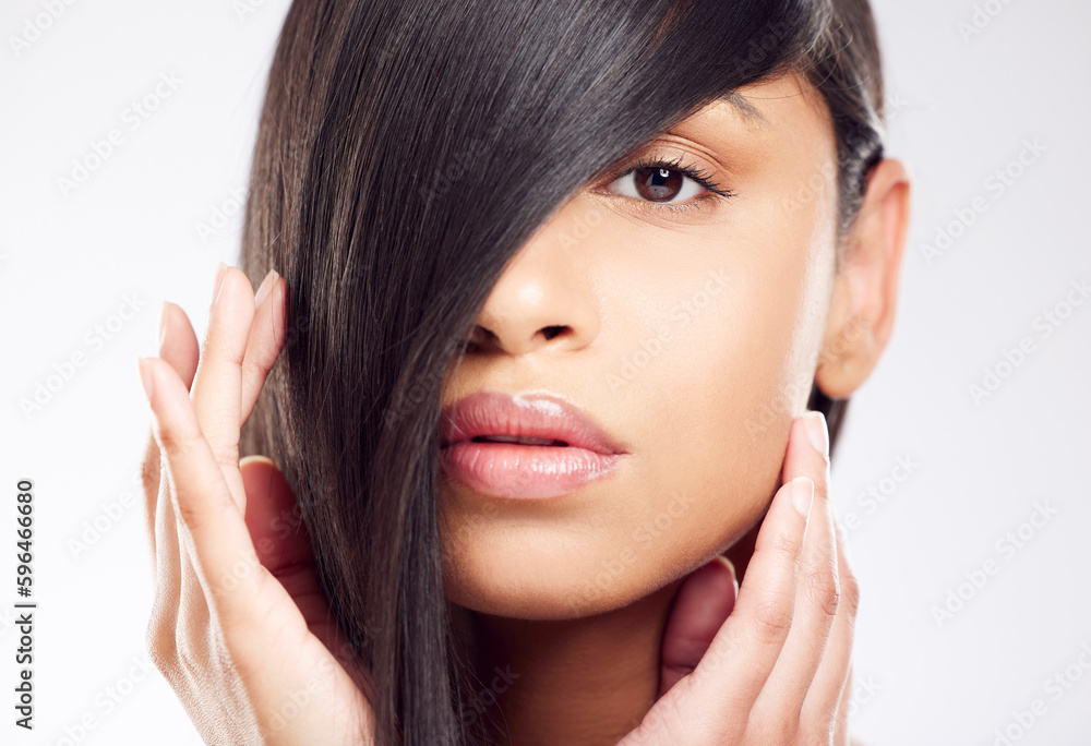 Beautiful hair is a statement. Shot of a young woman posing against a white background with healthy looking hair. Beautiful hair is a statement. Shot of a young woman posing against a white background with healthy looking hair.