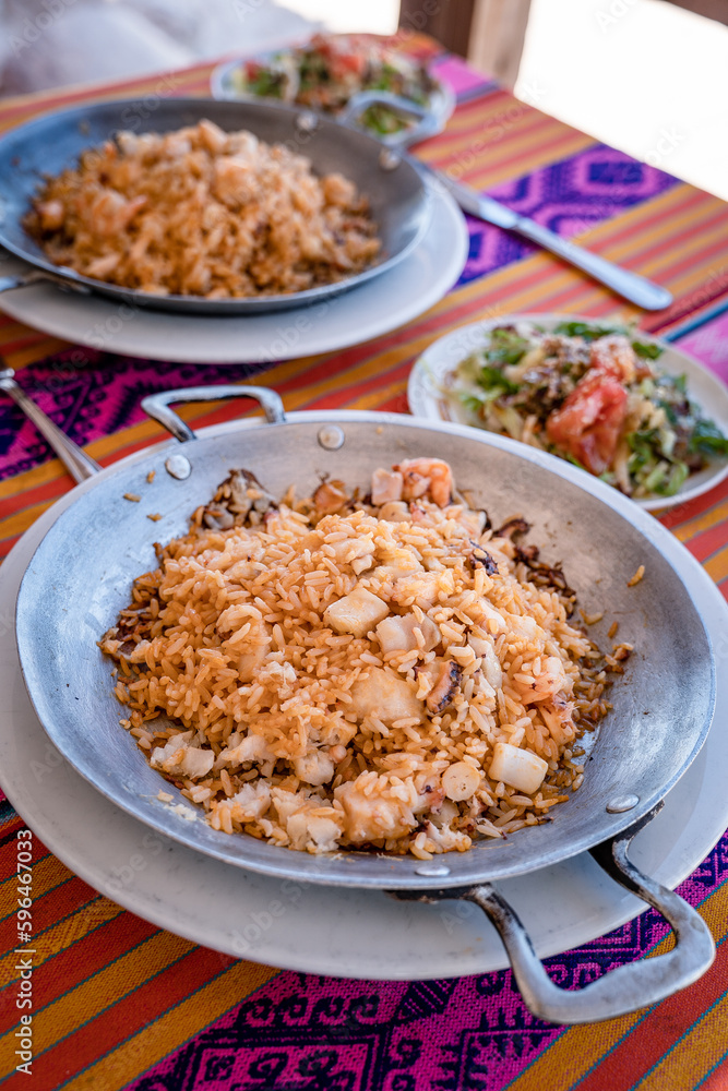 rice with shrimp on a metal pan and accompaniment from the Colombian tropics rice with shrimp on a metal pan and accompaniment from the Colombian tropics