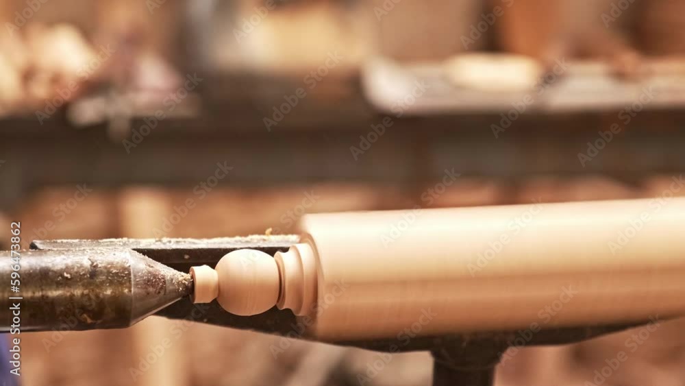 detail of master craftsman turner shaping a piece of wood on his craft lathe detail of master craftsman turner shaping a piece of wood on his craft lathe