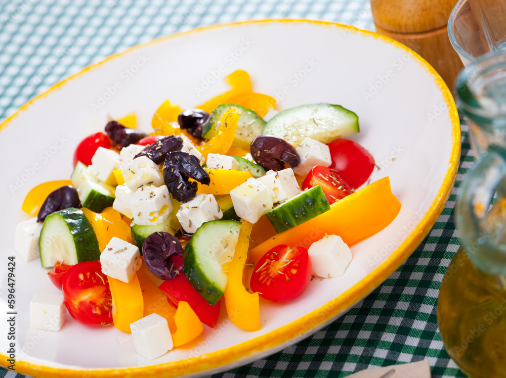 Delicious salad with tomatoes, cucumber, feta cheese and paprika