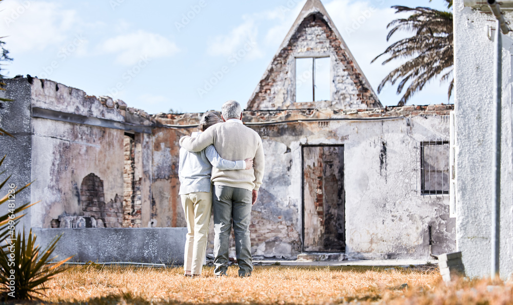 Insurance is the best investment. Shot of a senior couple comforting each other after losing their home to a fire.