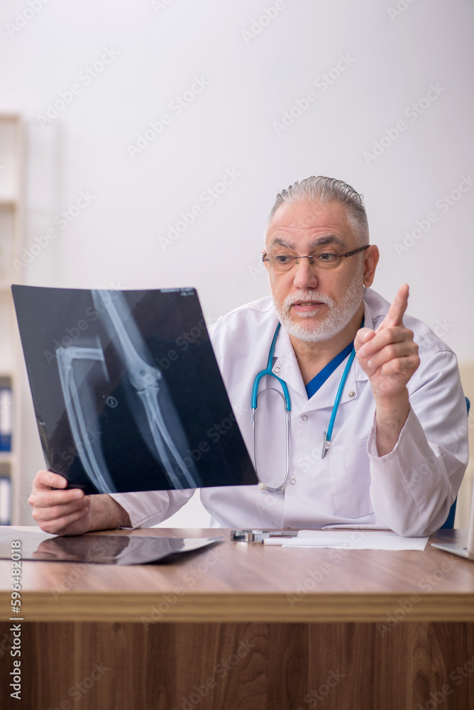 Old male doctor radiologist working in the clinic Old male doctor radiologist working in the clinic