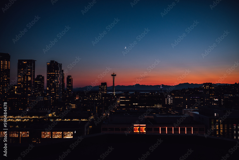 sunset, dusk, night view of Seattle skyline with crescent moon