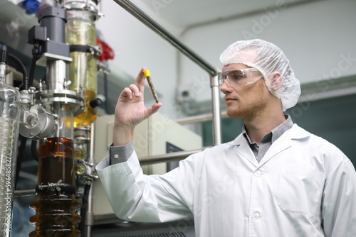 Obraz na płótnie scientist analyzing a biological and ecological hemp plant used for herbal pharmaceutical CBD oil and THC oil in a laboratory. w salonie