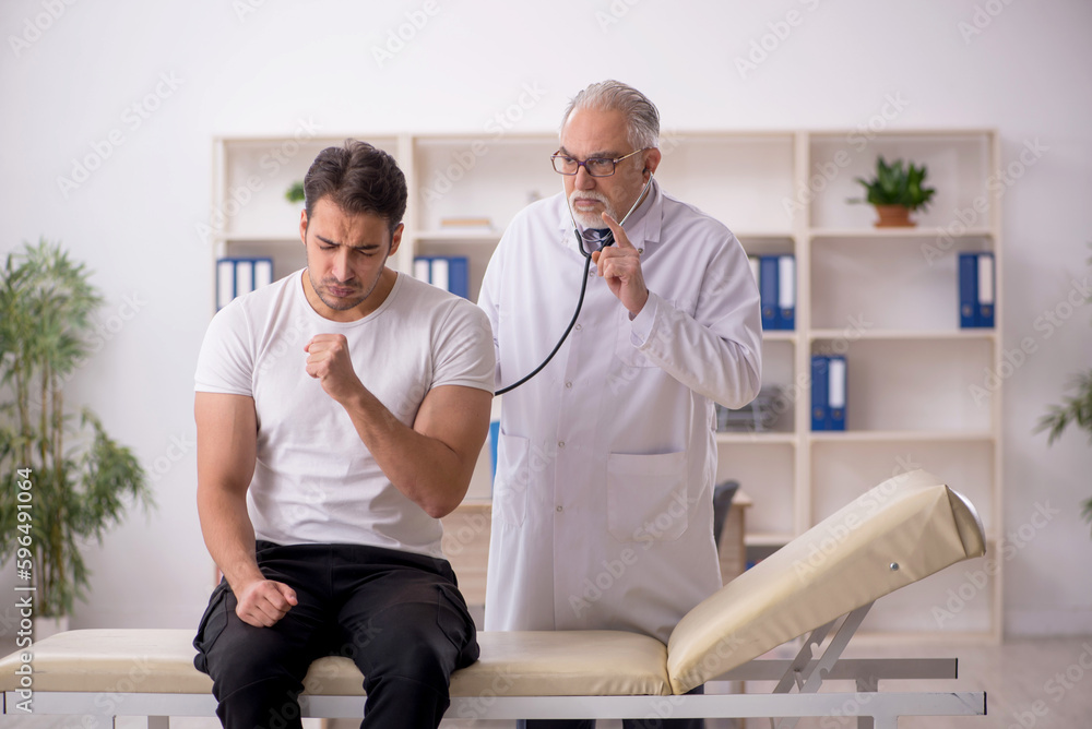 Fototapeta premium Young male patient visiting old male doctor