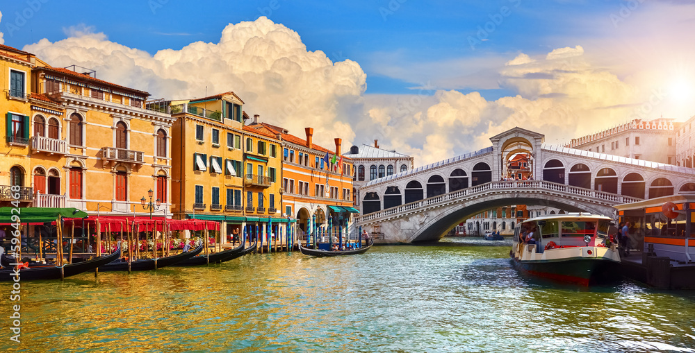 Venice, Italy. Rialto Bridge on Grand canal of Venezia. Famous landmark panoramic view venice with blue sky white clouds and gondolas water