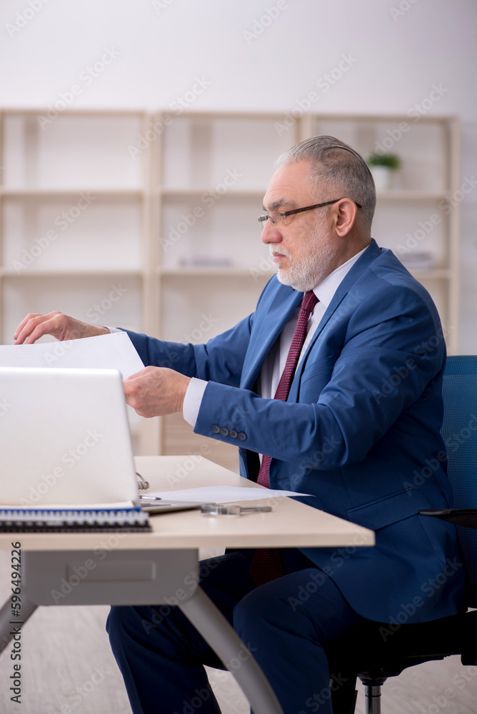 Old male employee and too much work at workplace Old male employee and too much work at workplace