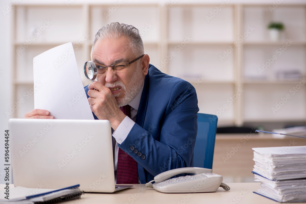Old male employee and too much work at workplace Old male employee and too much work at workplace