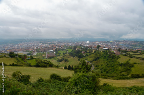 Spectacular views towards the city of Oviedo  from the viewpoint  under a very cloudy sky.