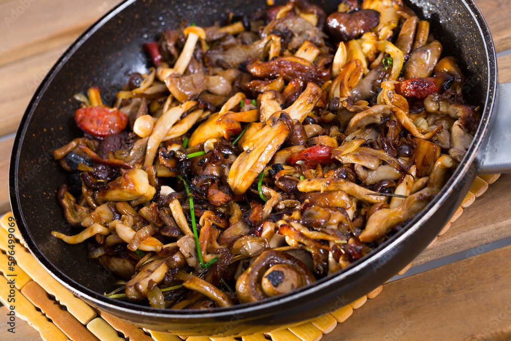 Fototapeta premium Close-up image of iron pan with freshly fried mushrooms