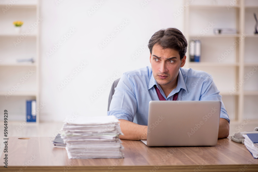 Young male employee working in the office Young male employee working in the office