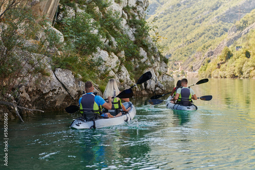 A group of friends enjoying having fun and kayaking while exploring the calm river, surrounding forest and large natural river canyons