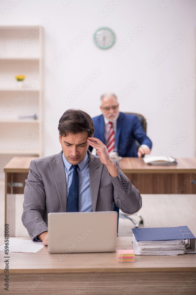 Two male colleagues sitting in the office Two male colleagues sitting in the office