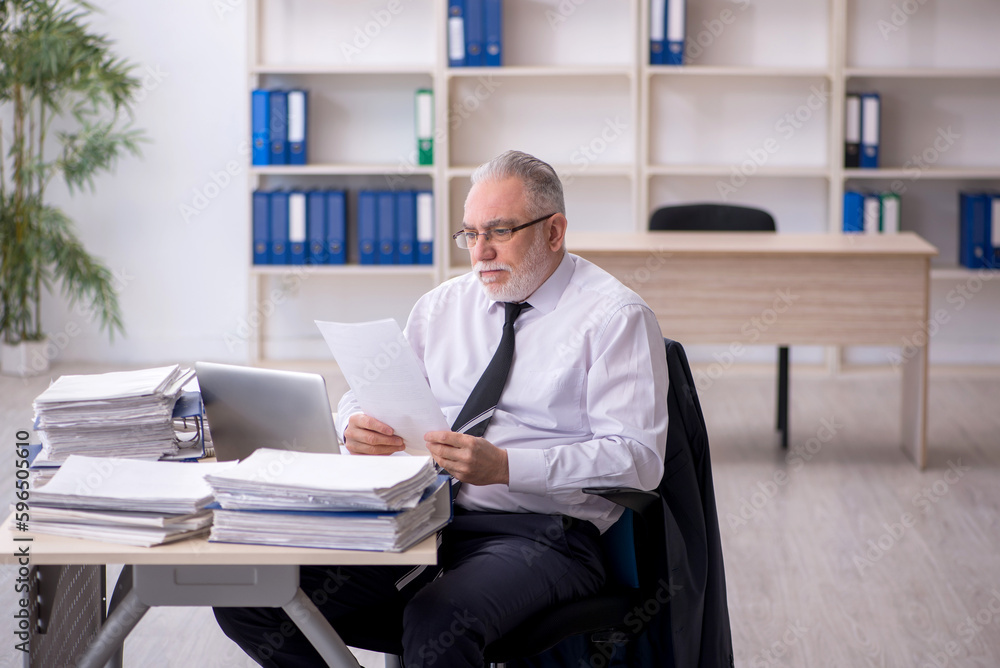 Old male employee and too much work at workplace Old male employee and too much work at workplace