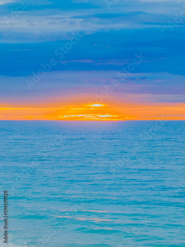 Colourful sunrise at the seaside with cloud cover