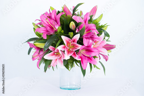 Wallpaper Mural Many kinds of flowers placed in a brightly colored vase in a white setting Torontodigital.ca