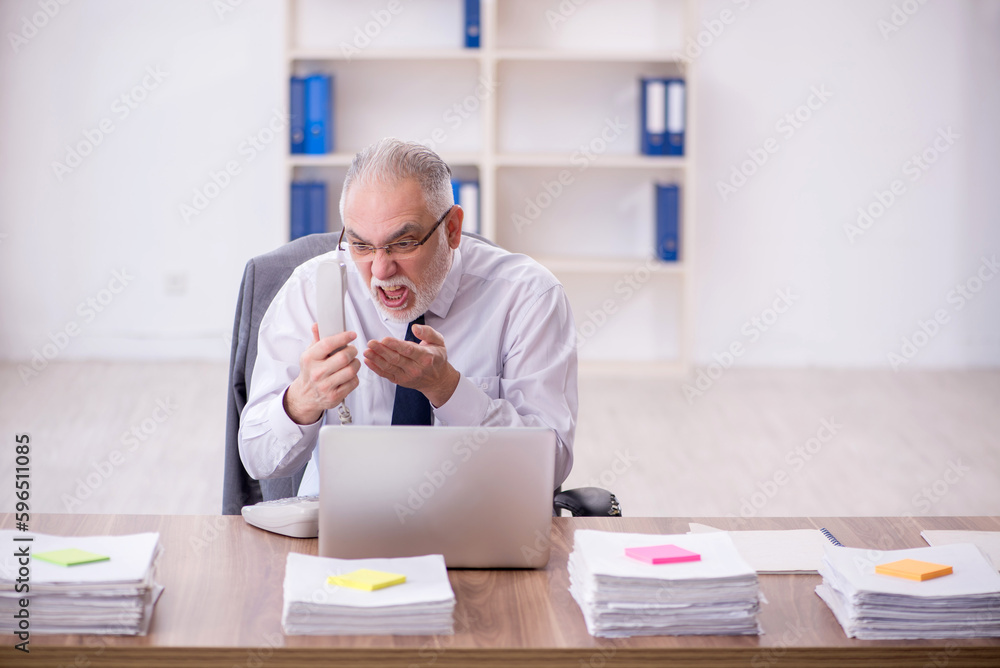 Old male employee and too much work in the office Old male employee and too much work in the office