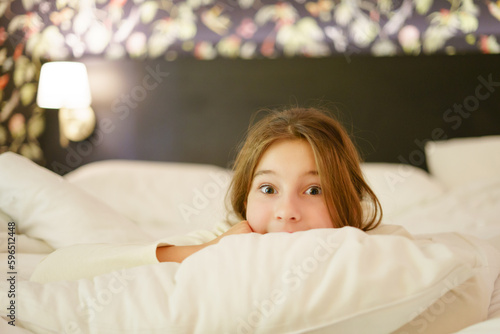 Wallpaper Mural Little cute girl smiling happily in her bed Torontodigital.ca