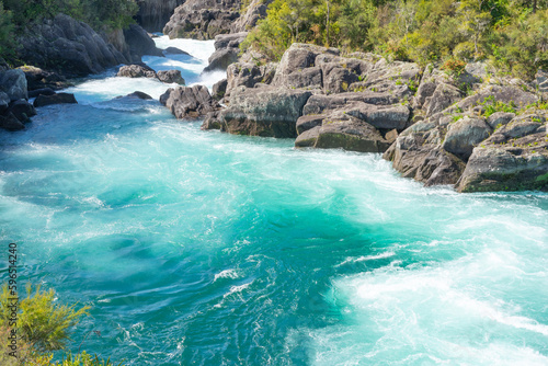 Swirling and surging river water through rocky ravine