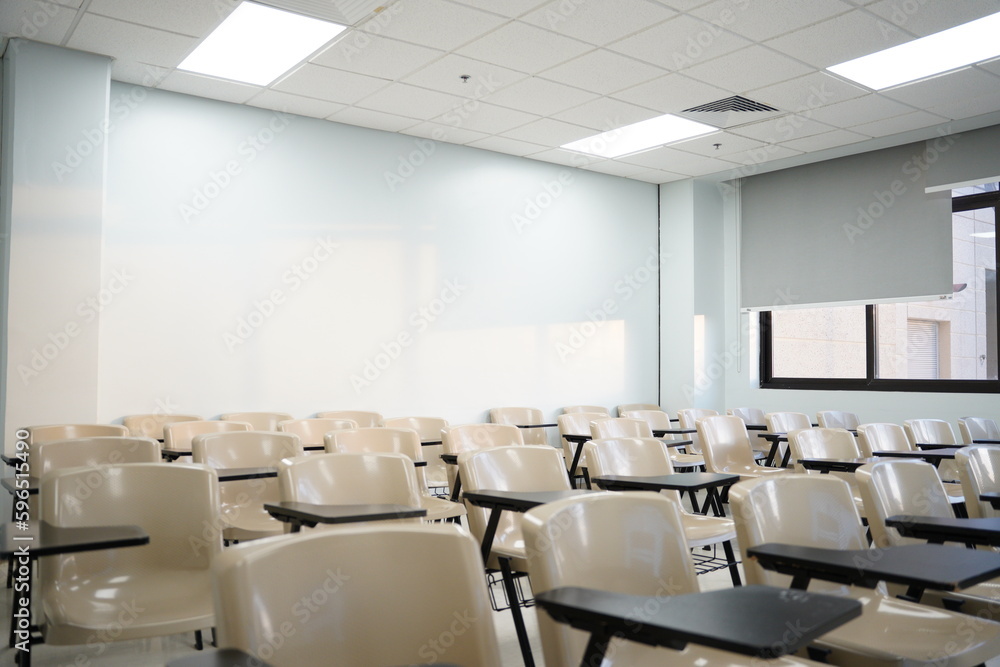 Empty classes at university or school with chairs and side tables, the chairs are arranged in rows. Empty classes at university or school with chairs and side tables, the chairs are arranged in rows.