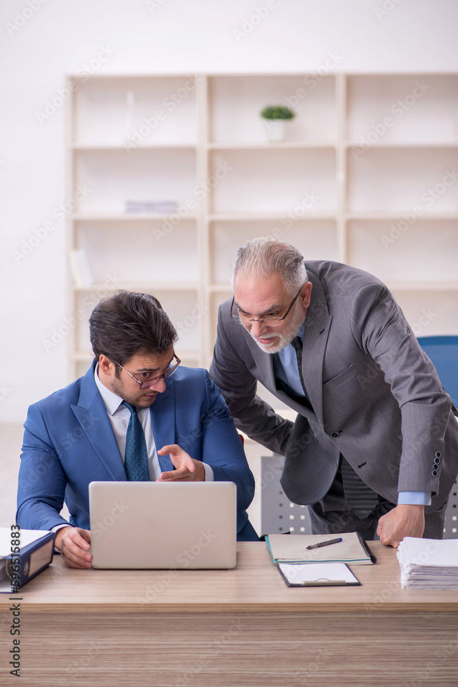 Two male colleagues working in the office Two male colleagues working in the office