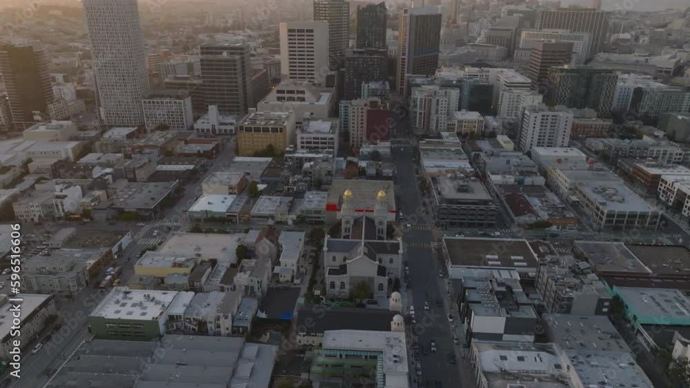 High angle view of church in town development. Tilt up reveal cityscape against twilight sky. High angle view of church in town development. Tilt up reveal cityscape against twilight sky.